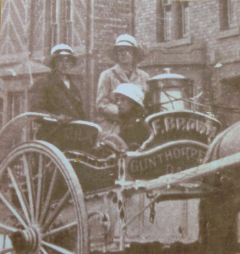 Close up of two land girls delivering milk in horse-drawn cart for Frederick Brown, Gunthorpe, Peterborough c1917