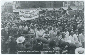 Land girls march with banner Join The Land Army For Health & Happiness, Peterborough 14 Sept 1918