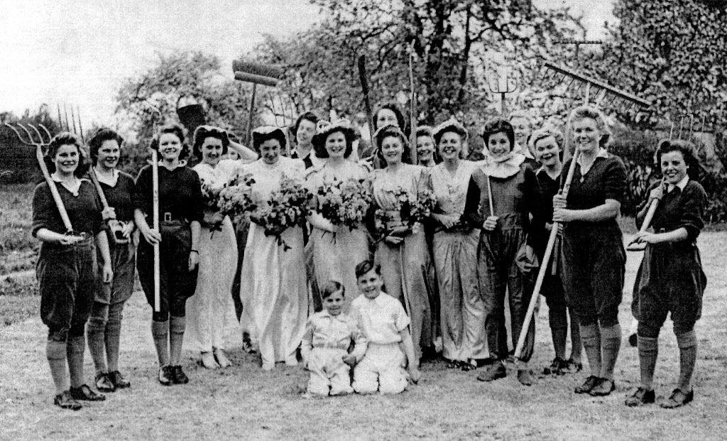 Peggy and her guard of honour. It shows the trouble that the land girls at that small hostel went to at that first event in 1944 to put on a really good show and involve a lot of people.