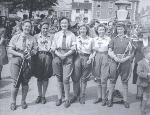 A group of Bedfordshire land girls who joined the crowds celebrating the VE Day radio announcement at 3pm in St Paul's Square, Bedford, 8 May 1945. 'Victory in Europe [VE] Day' marked the end of the Second World War in Europe. The Allies continued fighting in Japan in the Far East until VJ Day [Victory over Japan] on 15 August 1945. Source: Bedfordshire Times. Courtesy of Stuart