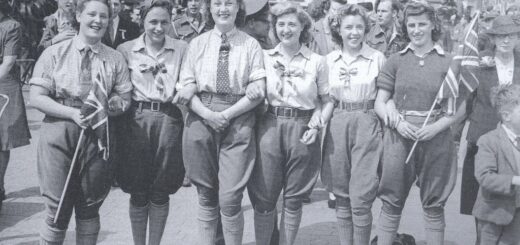 A group of Bedfordshire land girls who joined the crowds celebrating the VE Day radio announcement at 3pm in St Paul's Square, Bedford, 8 May 1945. 'Victory in Europe [VE] Day' marked the end of the Second World War in Europe. The Allies continued fighting in Japan in the Far East until VJ Day [Victory over Japan] on 15 August 1945. Source: Bedfordshire Times. Courtesy of Stuart