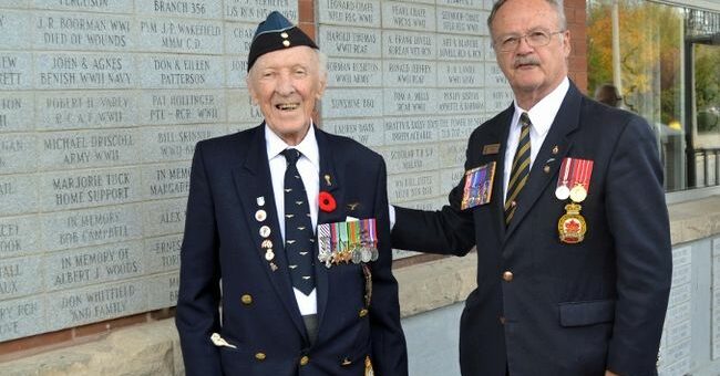 Fred Davies, left, looks on at Branch 34 president Rick Purcell unveils a paver Davies had placed in memory of Gladys Lillicrap.