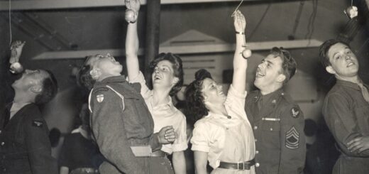 Caption: Ann Brodrick (left) with British serviceman and Mary Codrington with an American serviceman at a Halloween party c.1943 in Milton Ernest WLA hutment hostel, Bedfordshire.