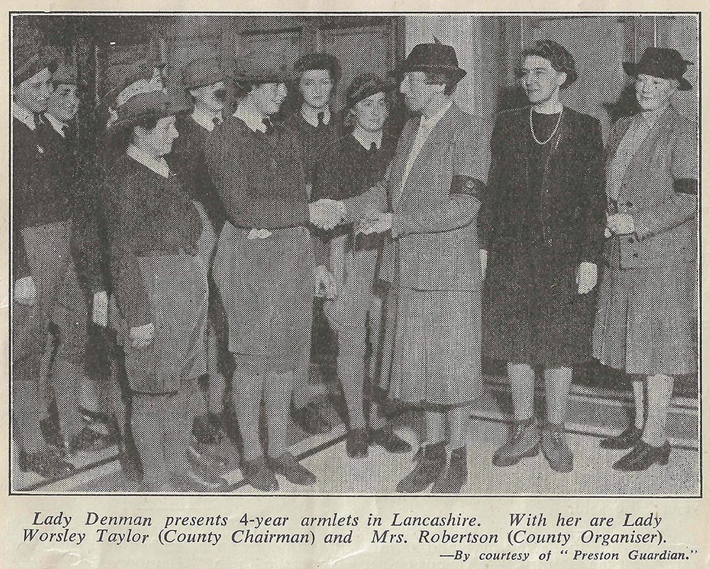 Lady Denman presents 4 year armlets in 1944.