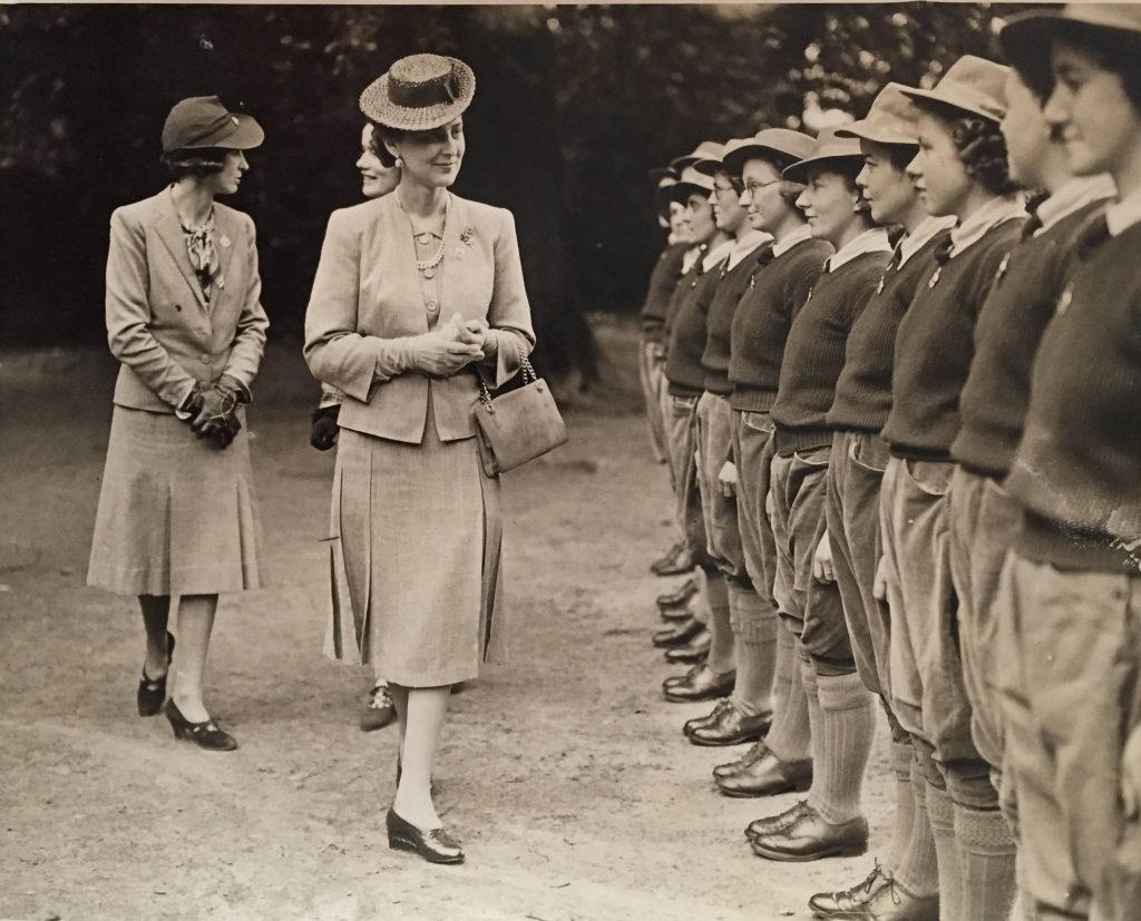 H.R.H The Duchess of Kent paid an informal visit to the new Y.W.C.A Land Army Hostel at Slough which was opened in response to the request of the Buckinghamshire Land Army Committee. The hostel used to be a boy's school, but began housing 50 girls working in market gardens. It had a large recreation room suitable for evening entertainments, an air raid shelter and a pleasant garden. 

Source: Catherine Procter WLA Collection.