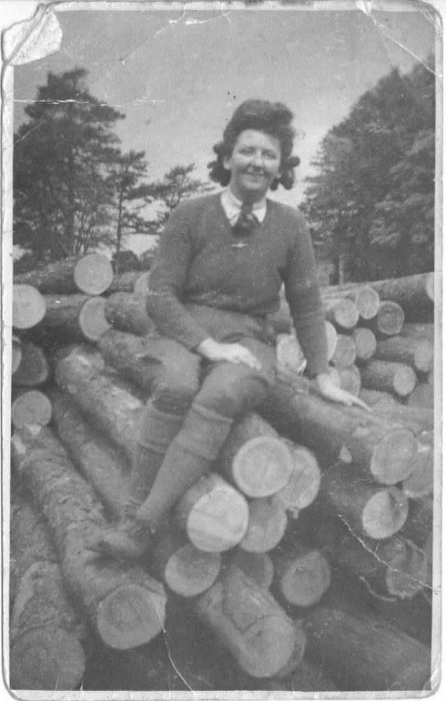 Gwyneth Mary Jones sitting on logs.