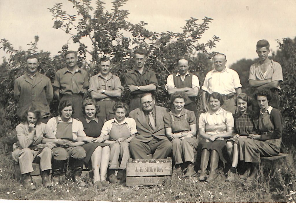 Mary pictured with other Land Girls and farmers on a fruit farm in Essex