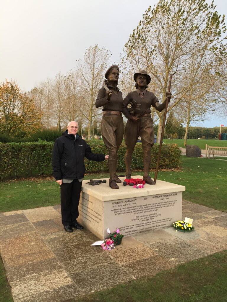 Stuart Antrobus standing next to the memorial to the WLA and WTC following its unveiling in October 2014 at the National Memorial Arboretum. 