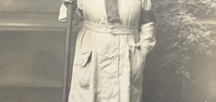 A First World War Land Girl holding a pitchfork.