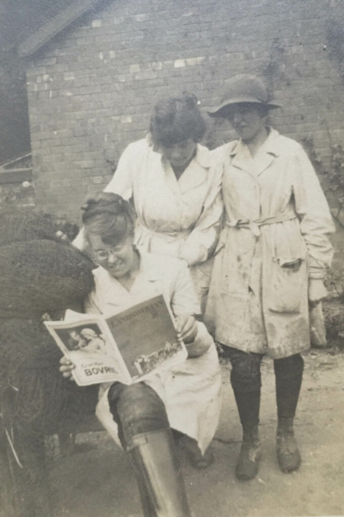 3 Land Girls reading The Landswoman.