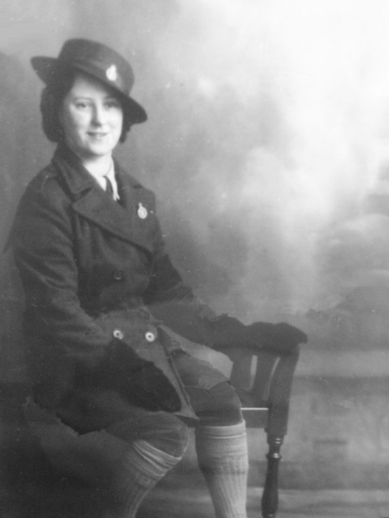 Anastasia seated in her WLA uniform.